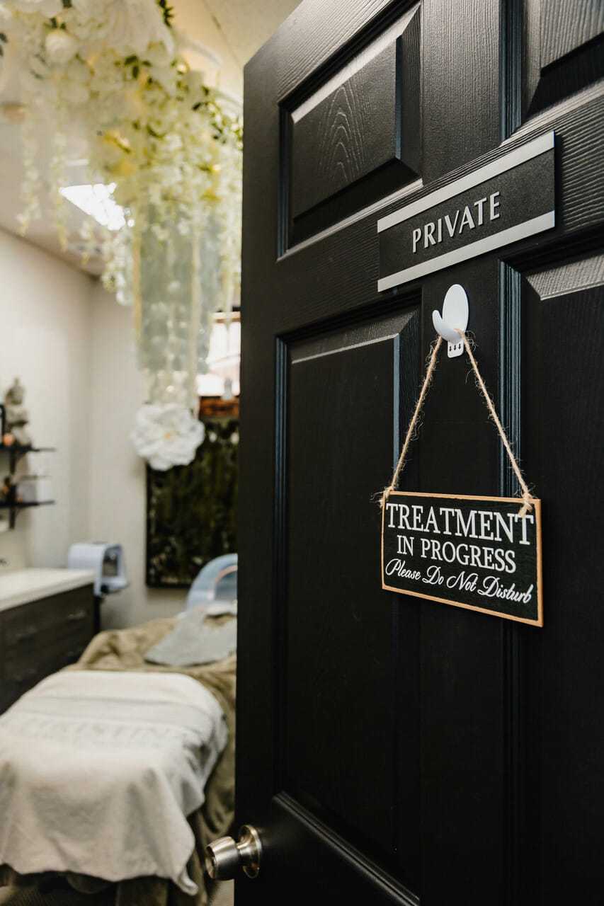 Private treatment room with "Do Not Disturb" sign on door. Interior is softly lit and inviting.